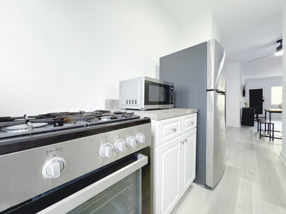Fully equipped kitchen with fridge, stove, microwave, and cookware (no dishwasher).