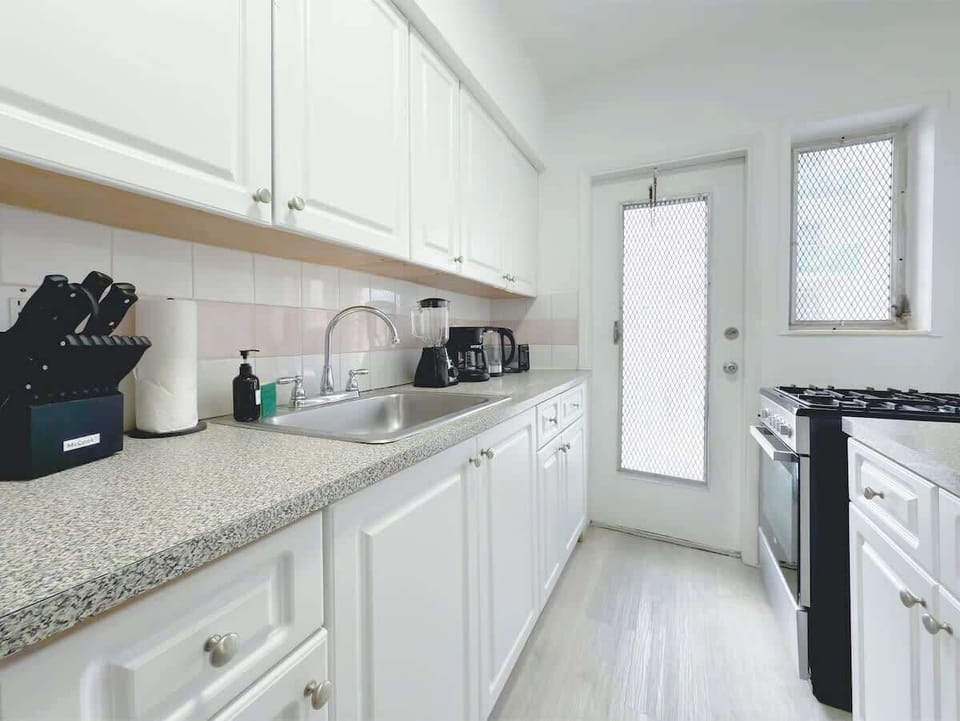 Fully equipped kitchen with fridge, stove, microwave, and cookware (no dishwasher).