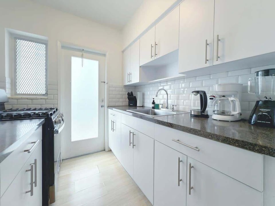 Fully equipped kitchen with fridge, stove, microwave, and cookware (no dishwasher).