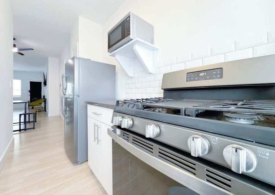 Fully equipped kitchen with fridge, stove, microwave, and cookware (no dishwasher).