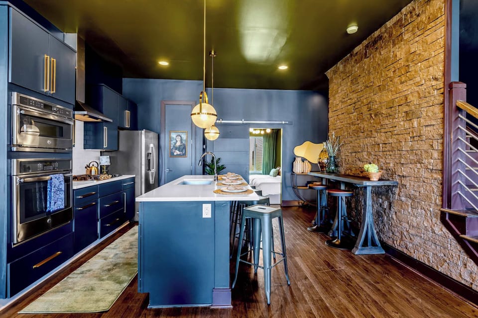 Enjoy features like this well stocked chef's kitchen with tasteful design features like a rock wall. 