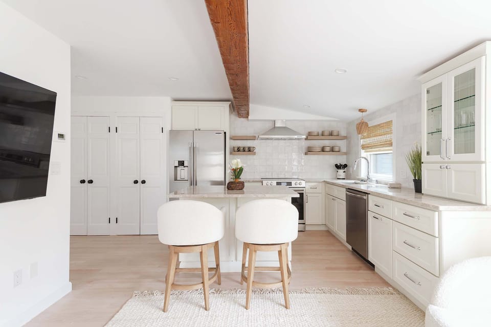 Open concept living with exposed beam ceilings