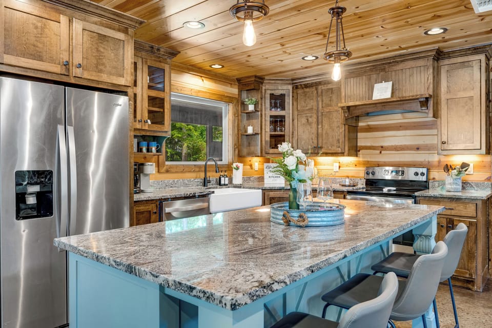 Rustic-chic gourmet kitchen with granite island and stylish seating