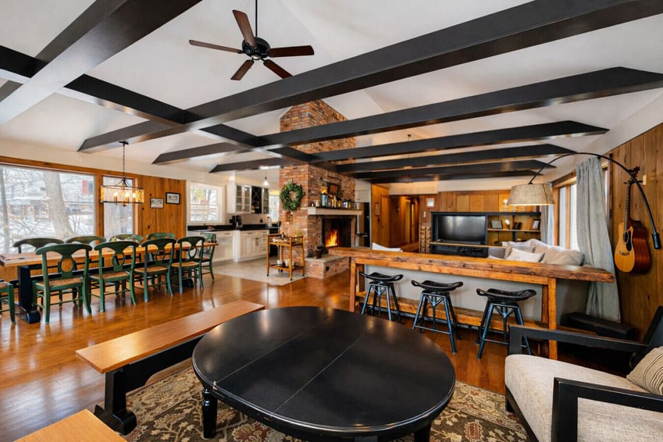 The camera pans wide. This expansive open-concept layout connects the kitchen, dining, and living areas so no one misses a moment of the action.
