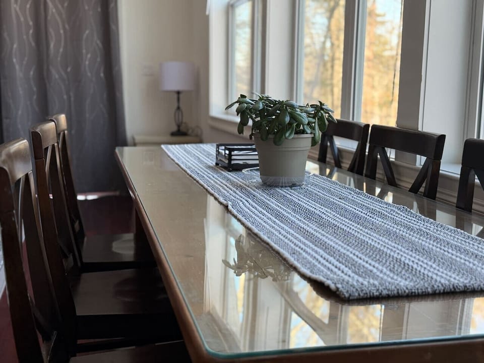 The heart of the home. Host memorable group dinners in our open-concept dining space framed by massive forest-view windows.