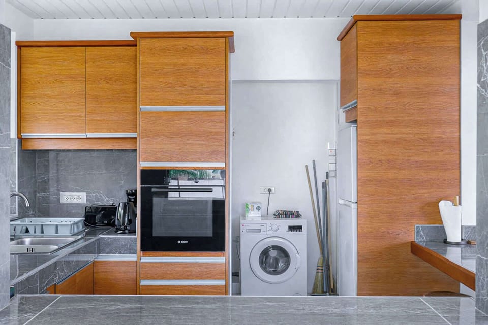 Bright, fully equipped kitchen with modern appliances and ample counter space.