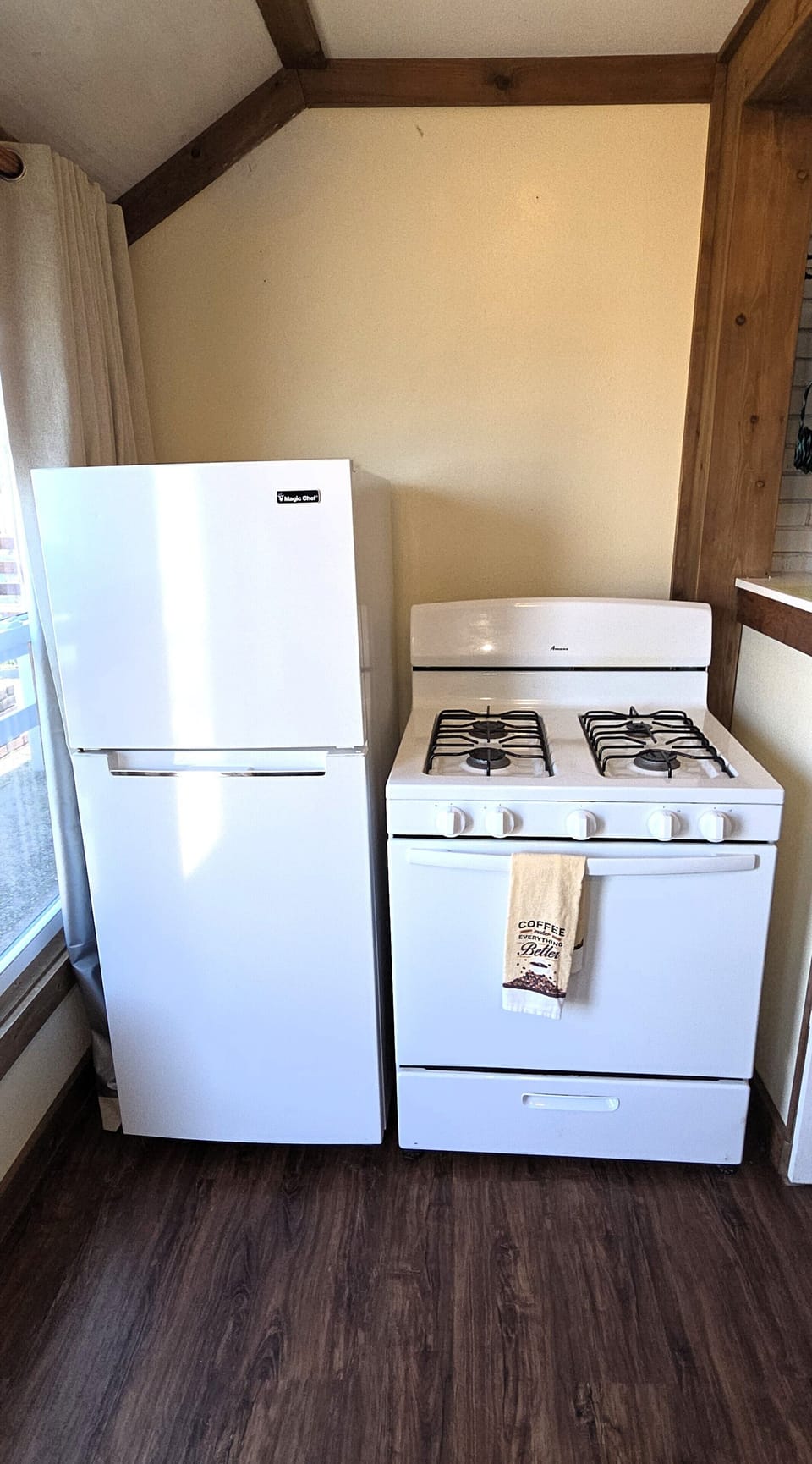 The kitchen has a gas stove and a refrigerator/freezer