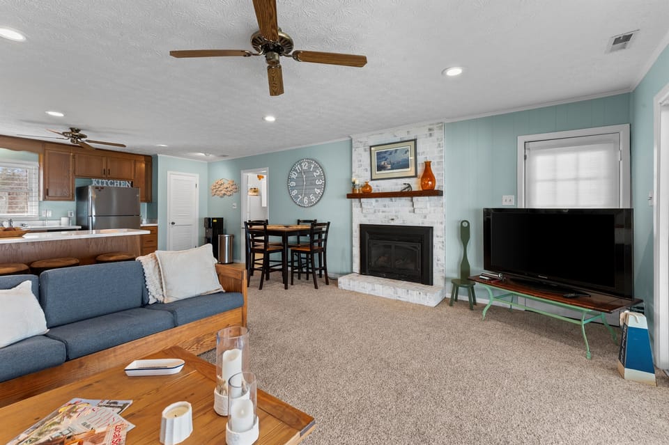 Living Room: Bright and inviting space with a fireplace, modern decor, and a perfect movie night vibe!