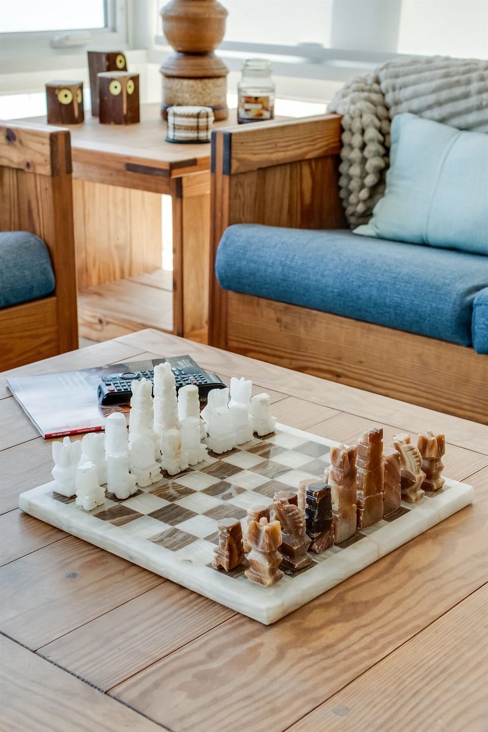 Living Room: Enjoy games and laughter over a unique chess set in a sunlit, stylish space!