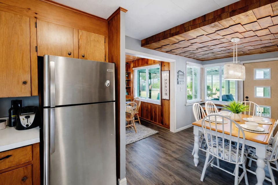 Kitchen | Stainless Steel Refrigerator | Dining Connection & Cabinet Storage