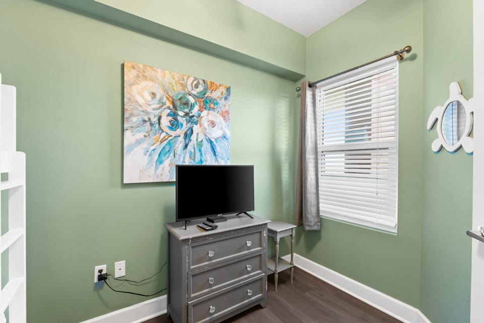 A large window brings in plenty of natural light, making the space feel bright and cheerful.