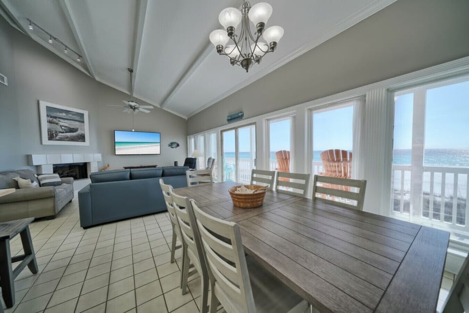 Spacious living area with vaulted ceilings, premium furnishings, and direct Gulf views. Beachfront dining. Elegant coastal interiors.