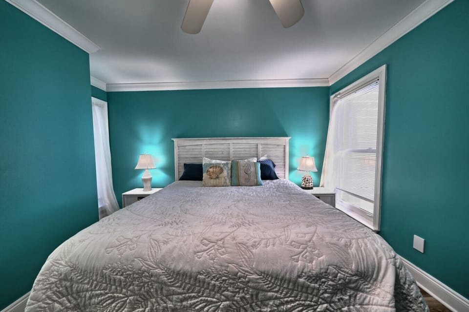 A tranquil haven, this queen bedroom offers bespoke comfort for a rejuvenating escape. Coastal elegance, curated for you.