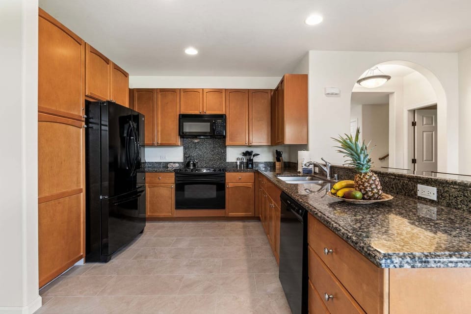 The kitchen is well-equipped with granite countertops, ample prep space, and everything needed for easy meals at home.