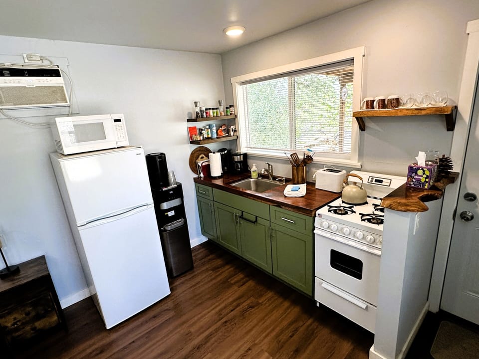 Full kitchen with stove/oven, refrigerator, microwave, toaster and coffee makers