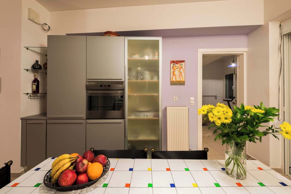 Modern kitchen space with sleek finishes and understated decorative touches.