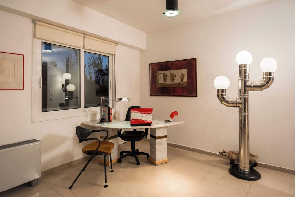 Desk area accented with artwork and natural light.
