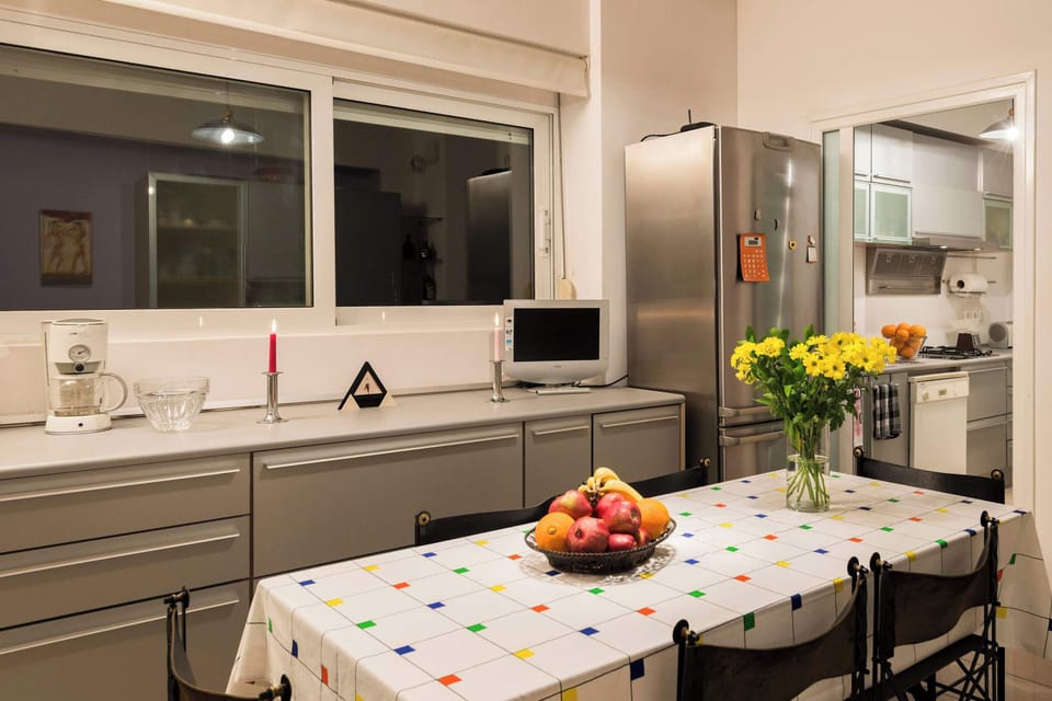 Clean-lined kitchen with wide windows and practical counter space.