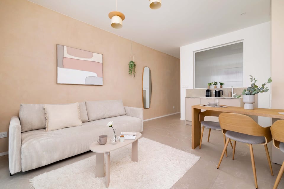 This wide shot captures the harmonious open-plan layout, blending the lounge and dining areas under soft lighting.