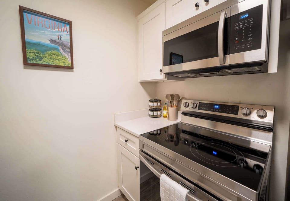 New stove and microwave in cozy, well-equipped kitchen