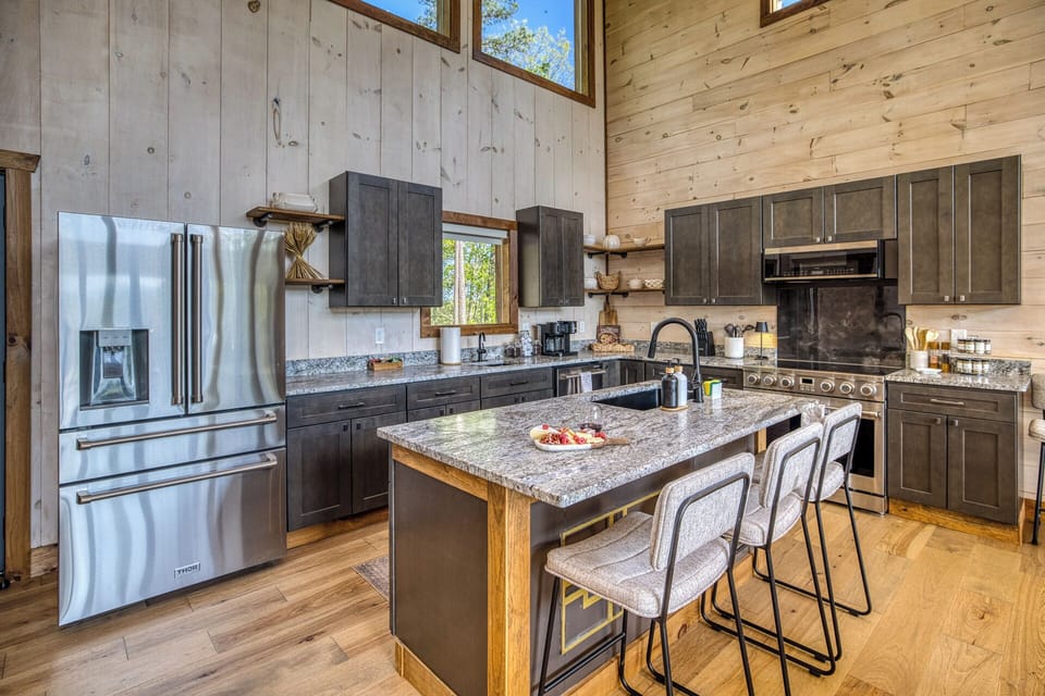 Prepare everything from quick breakfasts to holiday feasts in the fully stocked gourmet kitchen. Featuring granite countertops, stainless steel appliances, ample prep space, and seating at the oversized island, it's designed to keep everyone connected.