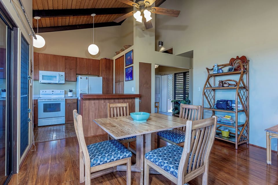 Gather around your dining table where ocean breezes flow through sliding doors creating a tropical ambiance.