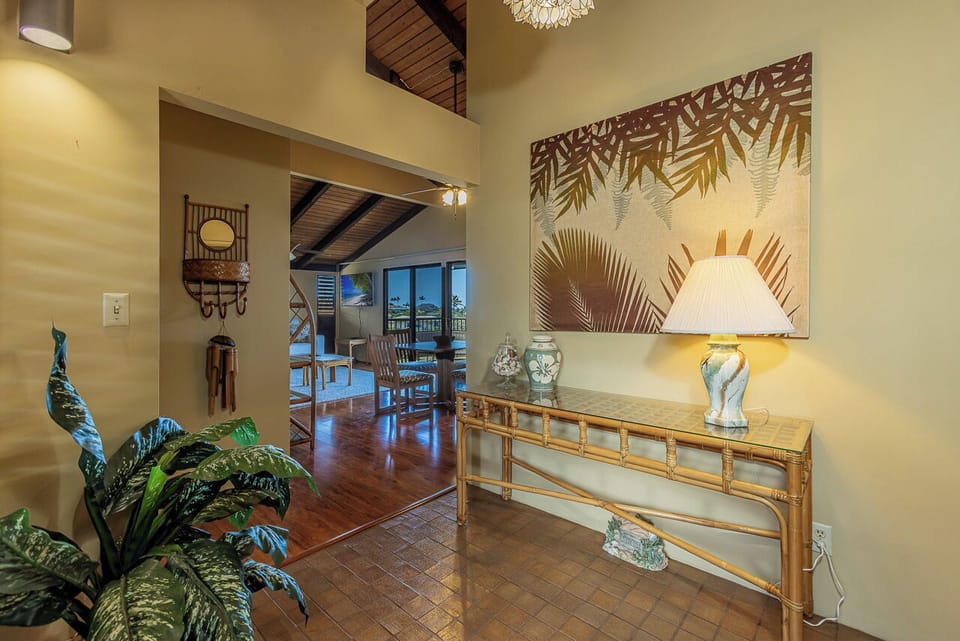 You'll love this tropical-inspired entryway with bamboo accents, lush plants, and warm island decor that welcomes you each day.