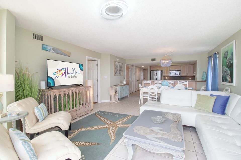 Relax in this coastal-chic living space with ocean-inspired decor, plush seating, and an open layout perfect for your beach getaway.