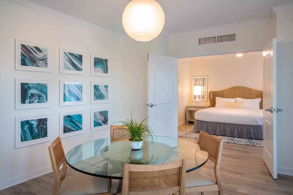 Savor moments of connection in the airy dining space, adorned with ocean hues, inviting light, and a touch of coastal elegance.