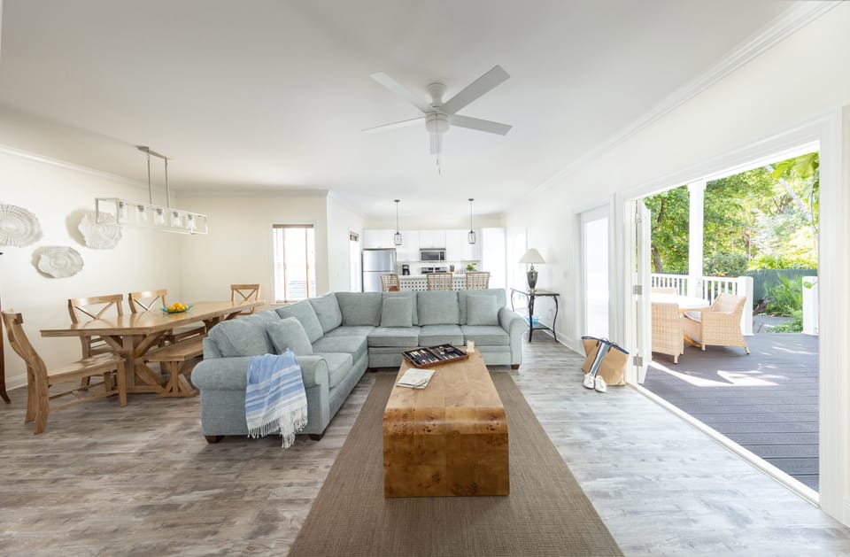 Sunlight filters across a sophisticated living room where coastal textures and soft hues create an atmosphere of comfort and calm.
