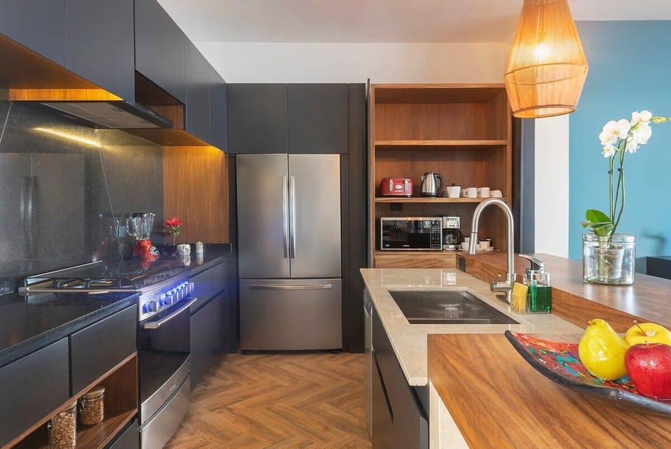 Fully equipped kitchen with modern appliances and dinnerware