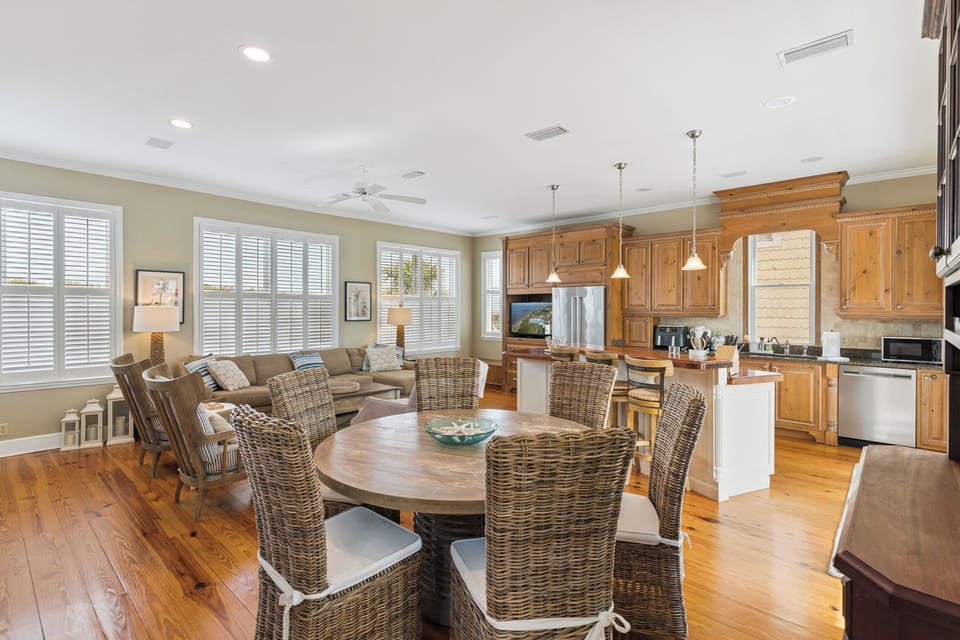 Gather around your elegant dining table while the chef prepares meals in your fully-equipped kitchen with warm wood cabinets and modern appliances.