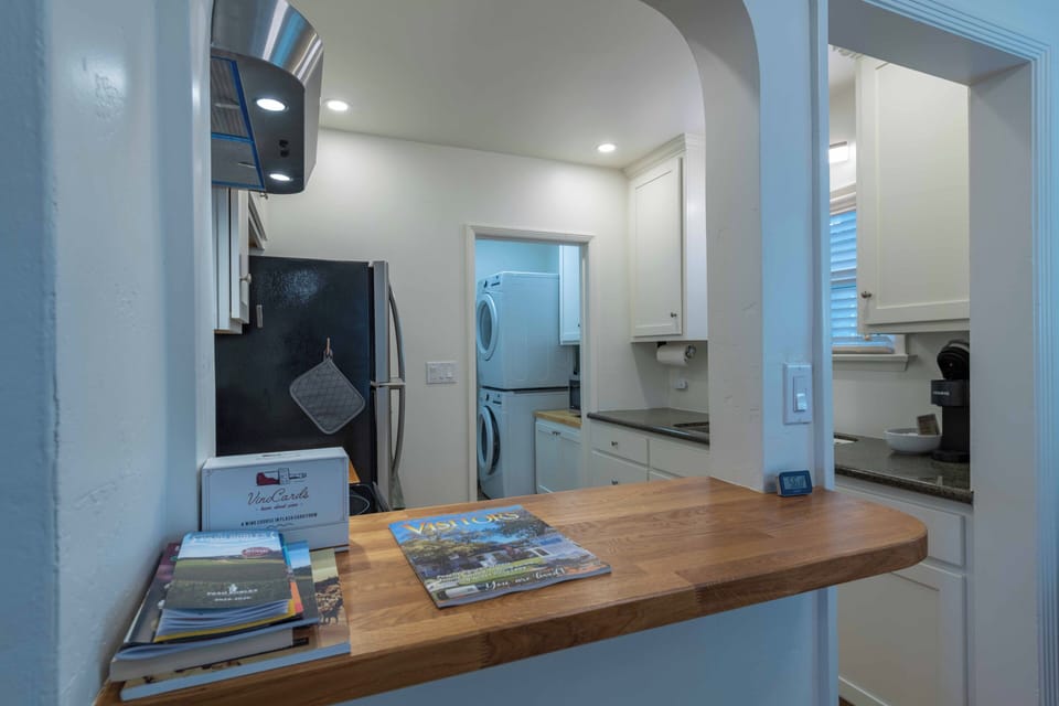 Your open kitchen flows seamlessly into the laundry area, complete with modern appliances and thoughtful touches like local guides.