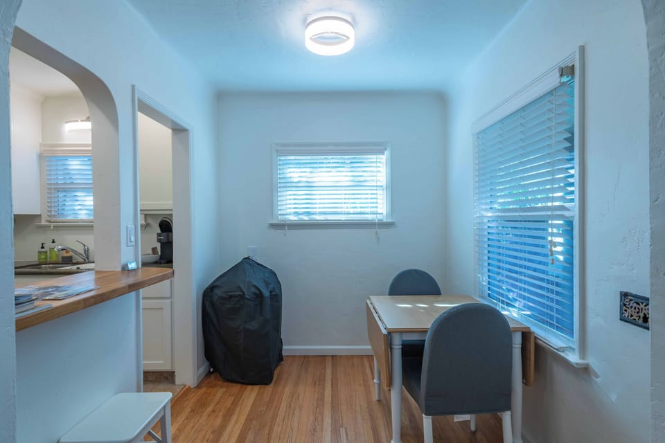 Your bright dining nook offers the perfect spot for morning coffee or intimate meals, with warm wood floors and natural light streaming through.