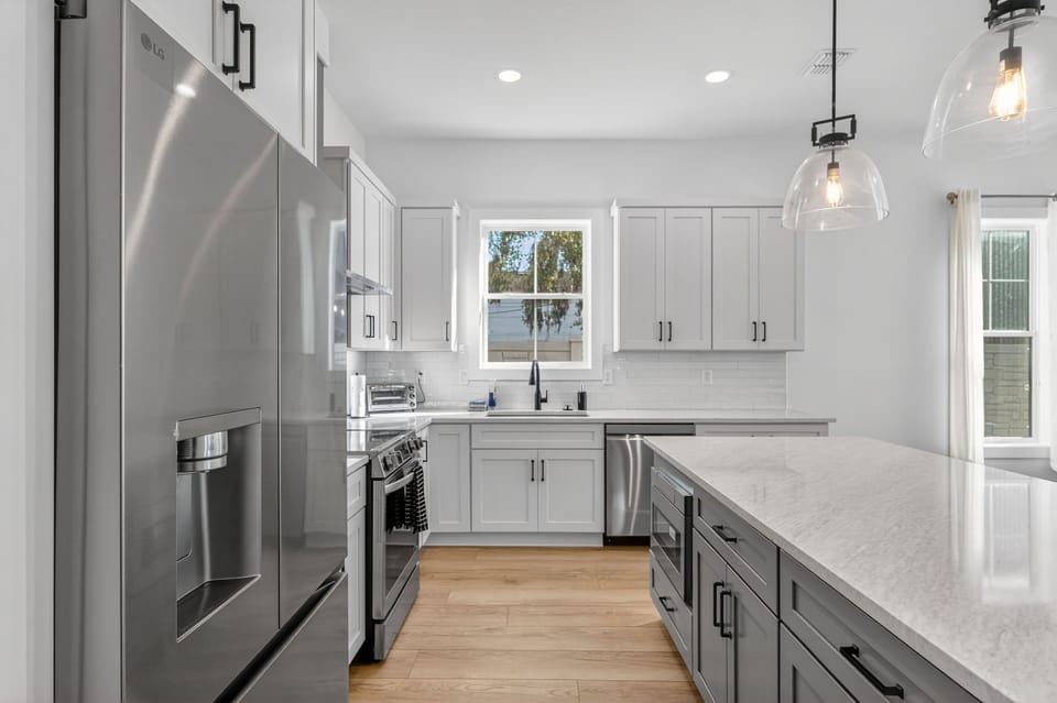 Blending modern elegance and coastal charm, this kitchen radiates warmth and style.