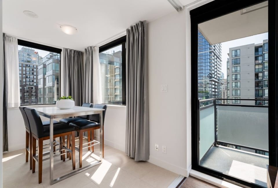 Bright and airy, this nook features large windows and modern furnishings, offering picturesque urban views of Vancouver's skyline.