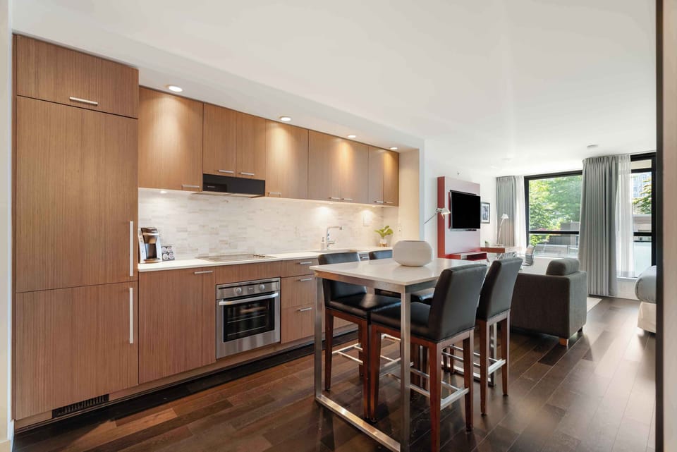 Spacious open kitchen with full-size appliances, a dining table, and bar seating designed for extended stays.