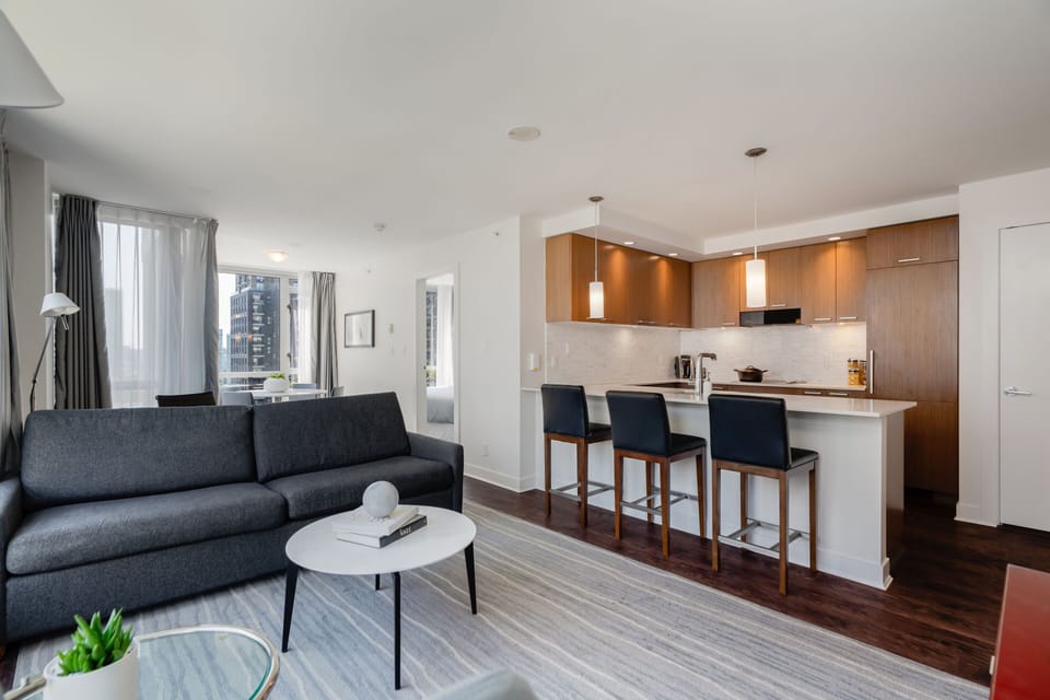 The open-concept design seamlessly integrates the stylish kitchen with modern amenities and a cozy dining area, perfect for entertaining.