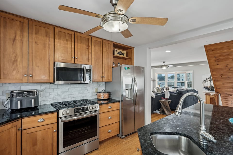 Your fully equipped kitchen features granite counters, stainless appliances, and warm wood cabinets for preparing memorable meals.