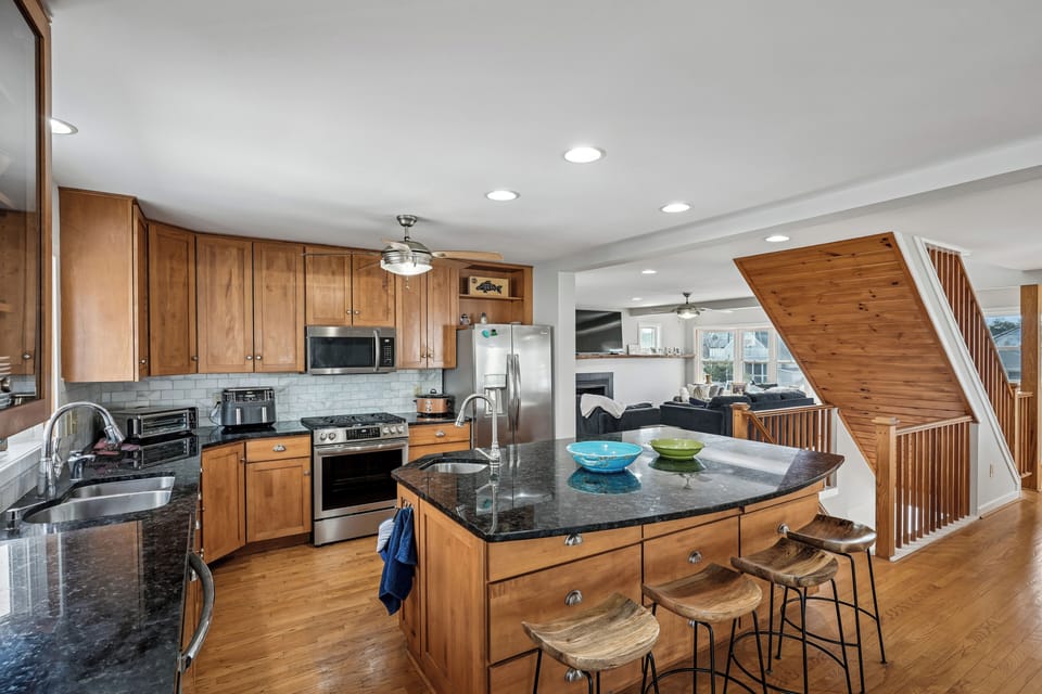 Your fully equipped kitchen features granite countertops, stainless steel appliances, and a breakfast bar where you can start your mornings with coffee.