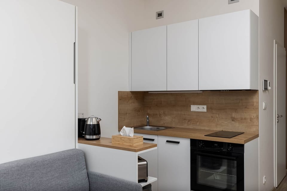 Compact, fully equipped kitchenette with modern appliances—perfect for preparing meals dur