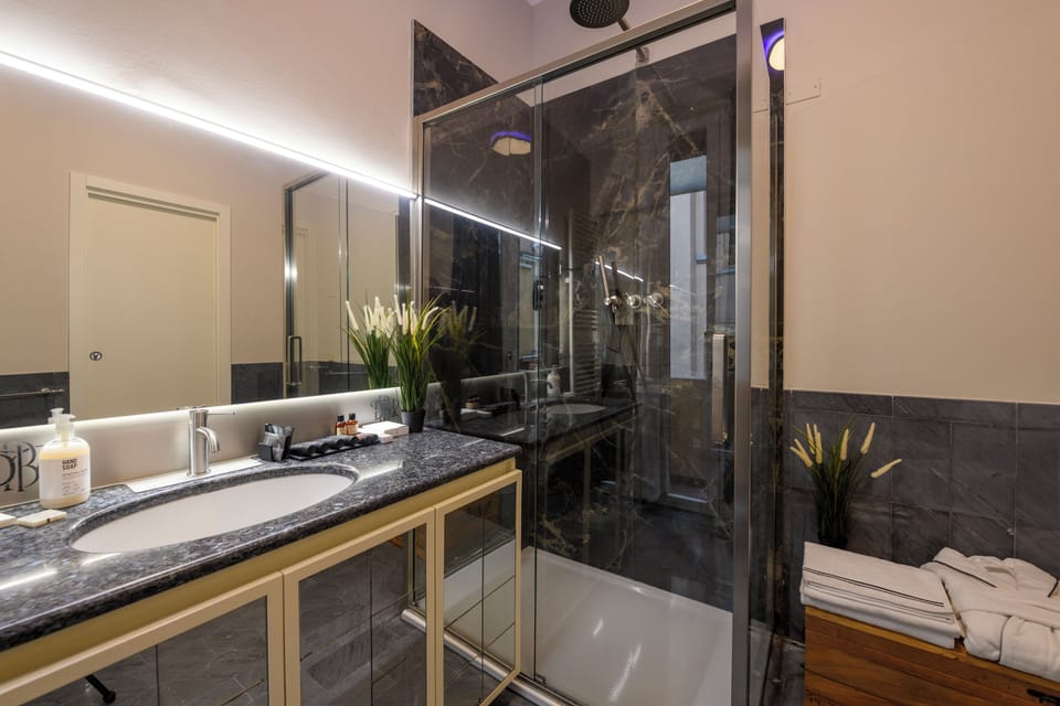 Luxury Quadruple Room, Courtyard View | Bathroom | Shower, hair dryer, towels, soap