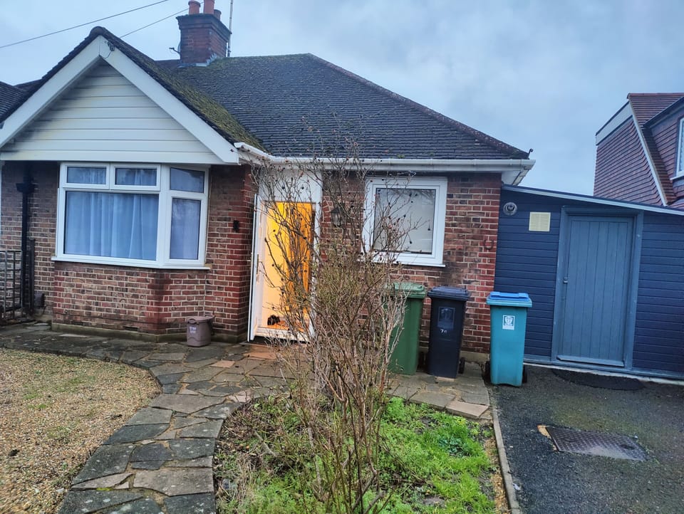 Exterior front, with entrance for large items ,wheel chair leads to laundry room