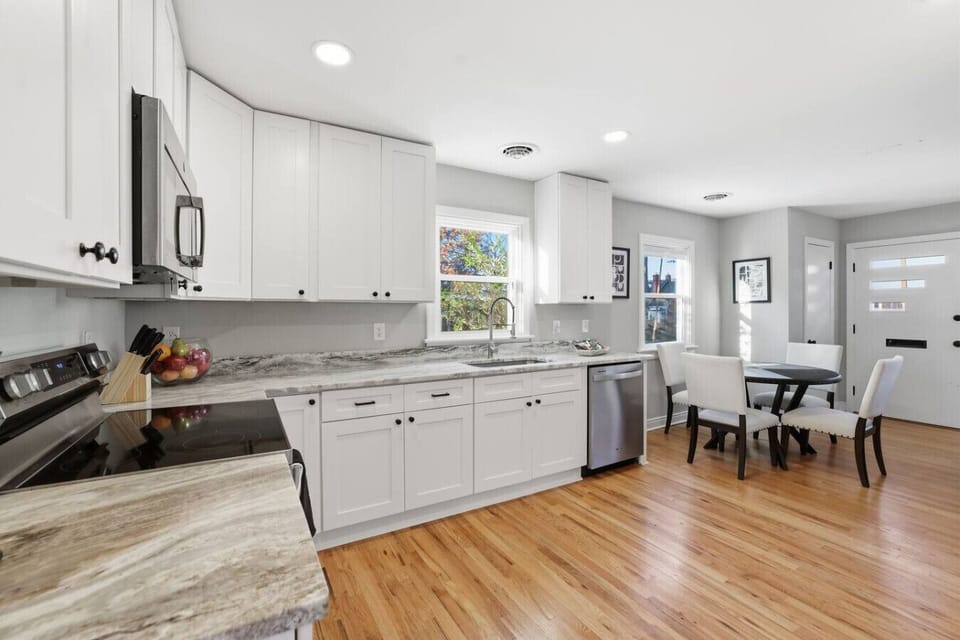 Fully renovated kitchen with stove, microwave, refrigerator and freezer, and dishwasher—flowing seamlessly into the dining room and conveniently located just off the laundry room. Enjoy a K-Duo coffee maker with complimentary coffee provided.