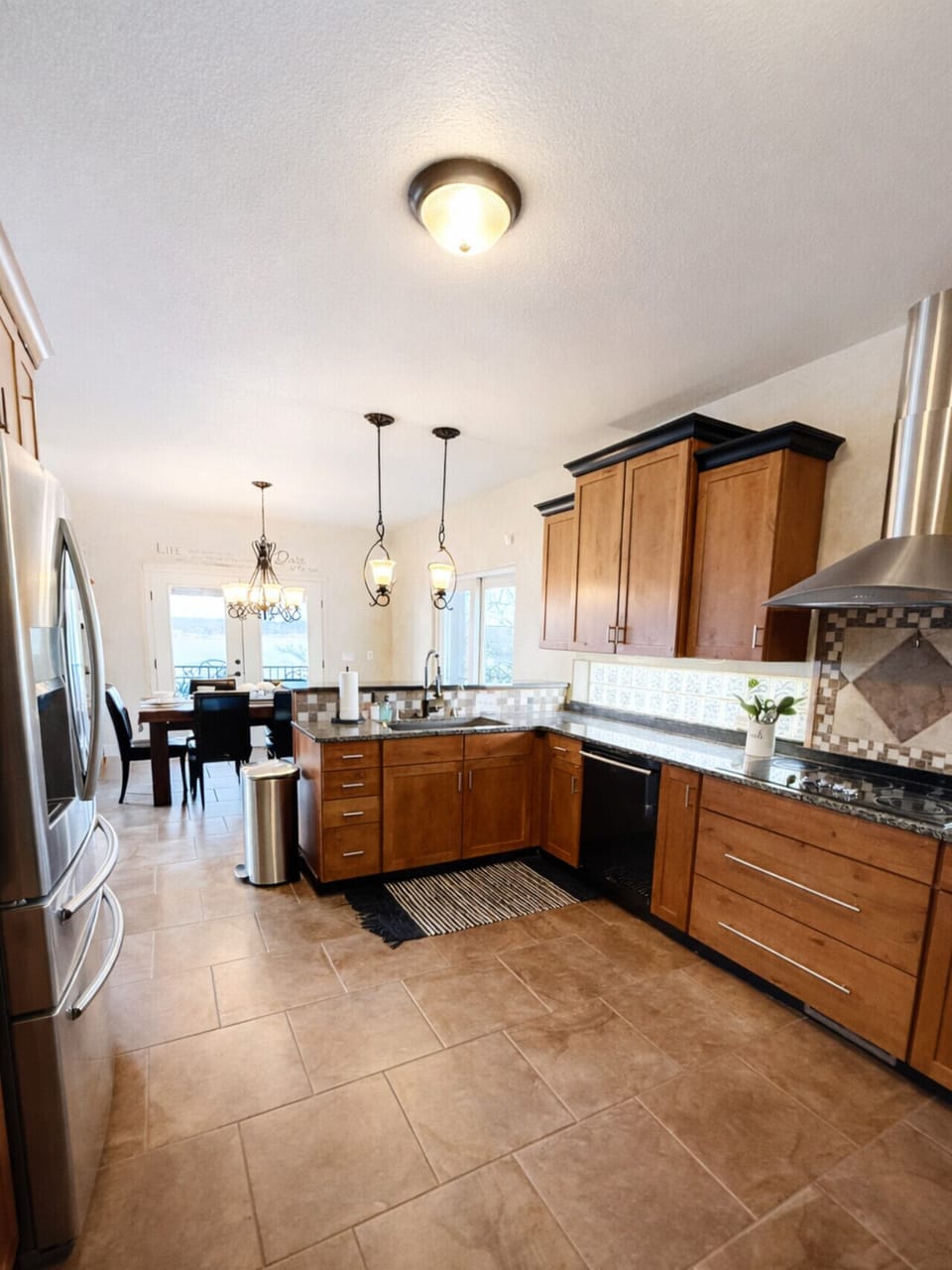 Spacious fully equipped kitchen with stainless steel appliances and granite countertops—perfect for cooking and entertaining during your vacation stay.