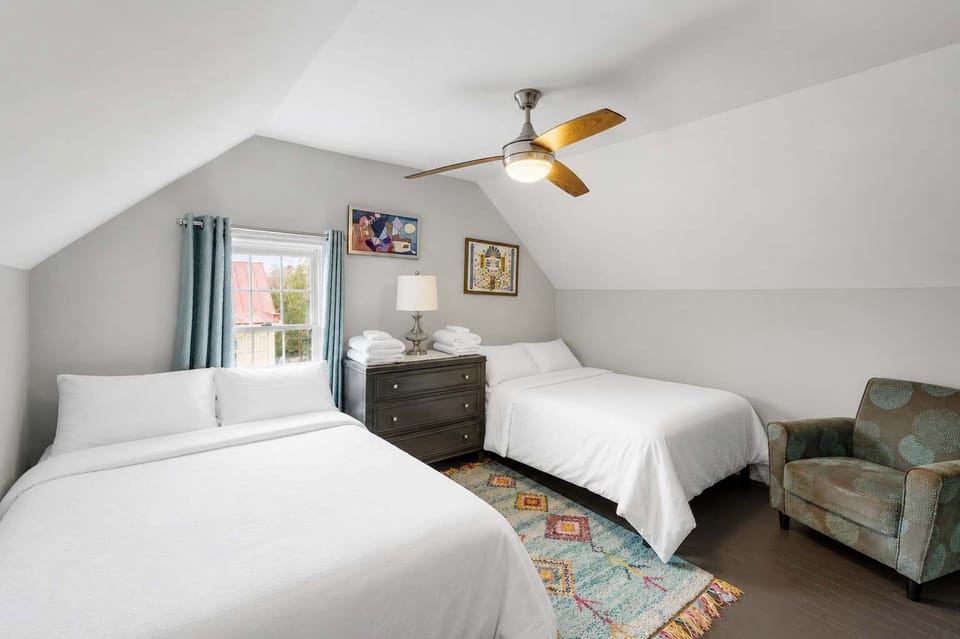 Bedroom 3: Perfect for families or friends, offering both a queen bed and double bed plus a seating nook.