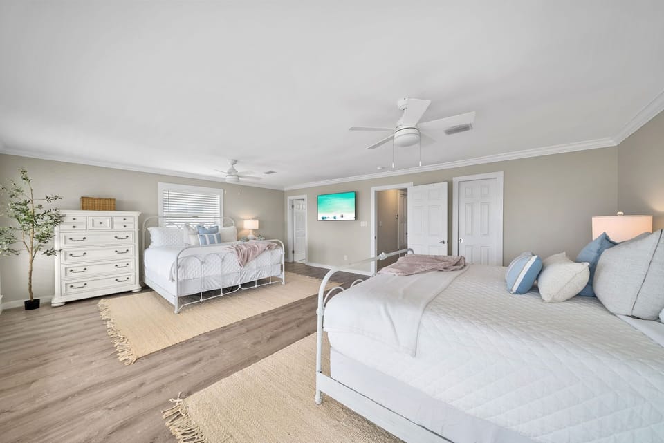 This spacious bedroom features two comfortable king beds.