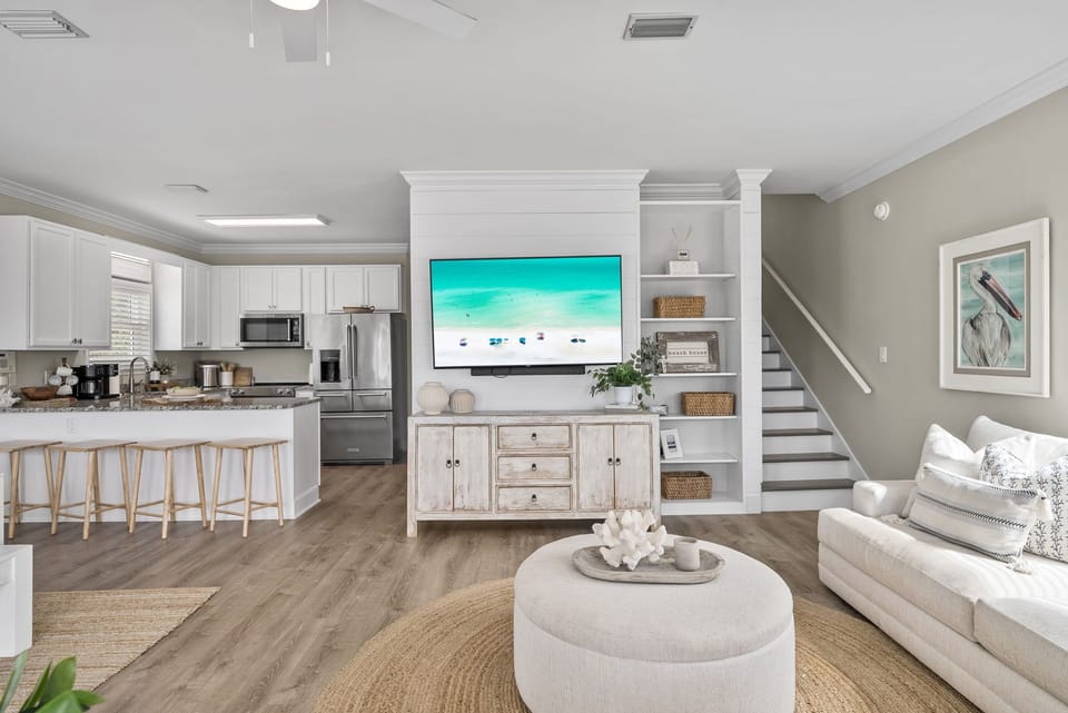 Relax in the cozy living room with comfortable seating and a large TV