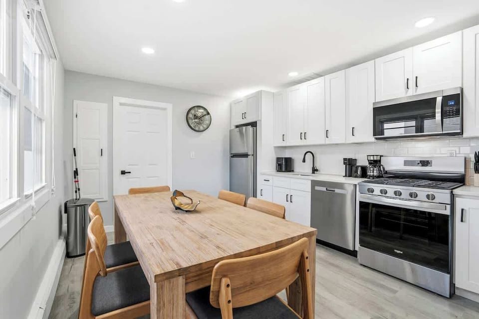 Spacious kitchen with ample cabinets and a dining table for six, perfect for families or group stays