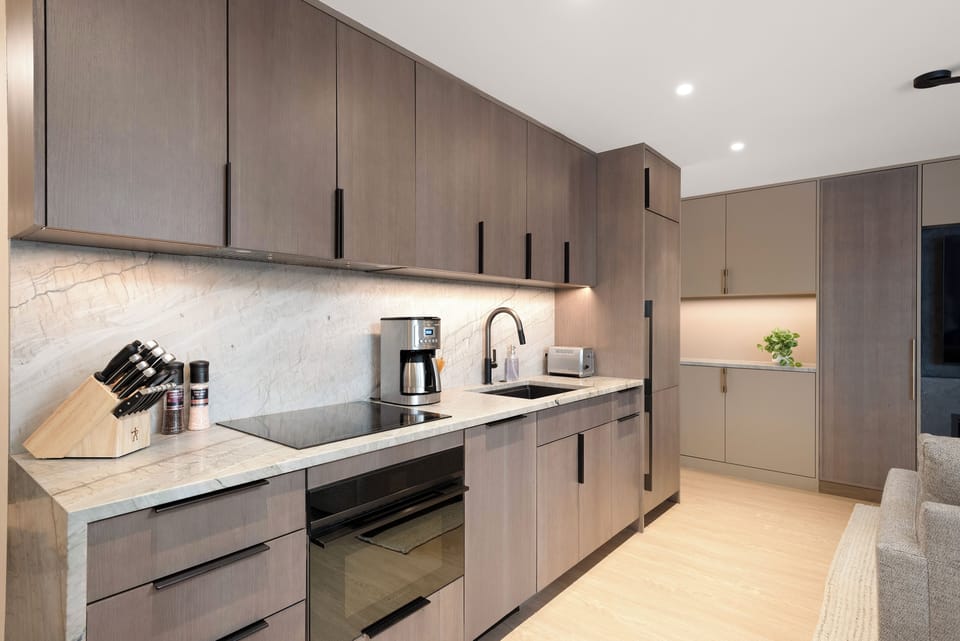 Fully-equipped kitchen with beautiful sleek cabinetry and high-end fixtures.